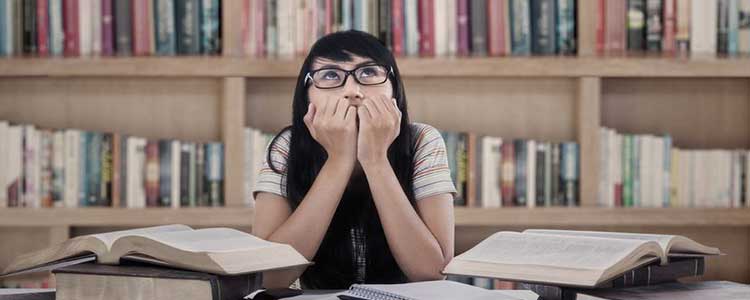 young woman thinking in a library