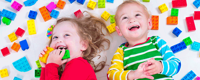 children playing with colourful lego blocks