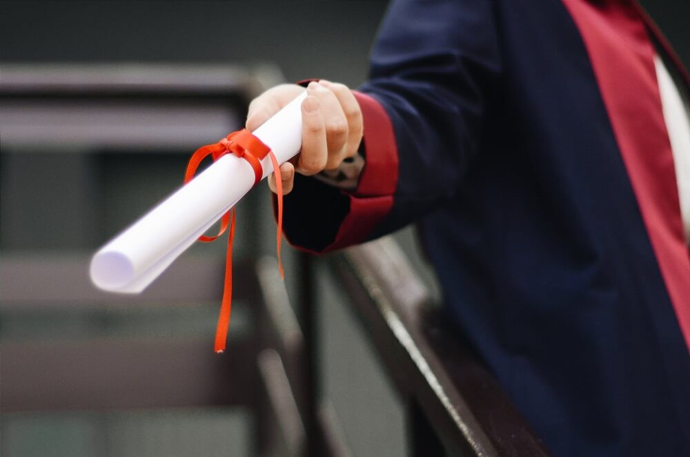 university student holding degree scroll